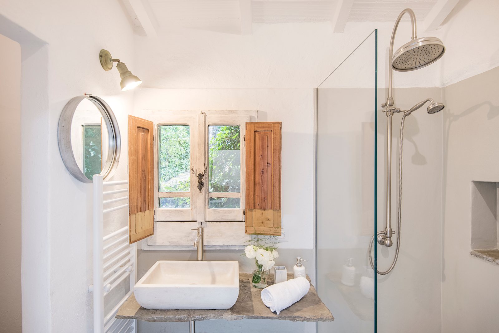 Shower room with a rain shower, glass screen and a stone sink